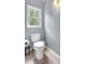 Cozy bathroom with a toilet next to the window and a decorative wall lamp at 4012 Ironhill Ln, Woodstock, GA 30189