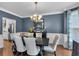Formal dining room with dark wood table, upholstered chairs, and crown molding at 4012 Ironhill Ln, Woodstock, GA 30189