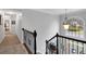 Upstairs hallway features neutral paint and a large decorative window at 4012 Ironhill Ln, Woodstock, GA 30189