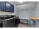 Functional laundry room with front load machines, cabinets, and plenty of folding space at 4012 Ironhill Ln, Woodstock, GA 30189