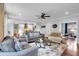 Spacious living room featuring hardwood floors, stylish furniture, and an open layout connecting to the kitchen, perfect for entertaining at 4012 Ironhill Ln, Woodstock, GA 30189
