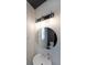 Modern powder room with round mirror, vanity and light fixture at 4450 Richmond Ct, Stone Mountain, GA 30083