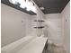 Modern bathroom with double sinks, granite counters, black accents, and a shower-tub combo at 4450 Richmond Ct, Stone Mountain, GA 30083