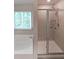 Modern bathroom with a tiled walk-in shower and a soaking tub at 4450 Richmond Ct, Stone Mountain, GA 30083