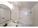 Bright bathroom with white vanity, arched mirror and modern shower-tub combo at 4450 Richmond Ct, Stone Mountain, GA 30083
