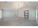 Spacious bedroom with vaulted ceiling, carpet flooring, and stylish chandelier at 4450 Richmond Ct, Stone Mountain, GA 30083