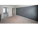 Spacious bedroom with gray accent wall and neutral carpeting, providing a calming atmosphere at 4450 Richmond Ct, Stone Mountain, GA 30083