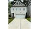 Charming two-story home with a two-car garage, landscaped front yard, and a well-maintained driveway at 4450 Richmond Ct, Stone Mountain, GA 30083