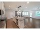 Bright kitchen with granite countertops, stainless steel appliances, and a view into the living room with a fireplace at 4450 Richmond Ct, Stone Mountain, GA 30083