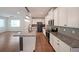 Modern kitchen with granite countertops, white cabinets, and stainless steel appliances at 4450 Richmond Ct, Stone Mountain, GA 30083