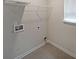 Convenient laundry room with tile floors and utility connections at 4450 Richmond Ct, Stone Mountain, GA 30083