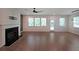 Spacious living room with fireplace, hardwood floors, and ample natural light at 4450 Richmond Ct, Stone Mountain, GA 30083