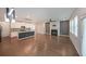 Open floor plan with fireplace, hardwood floors, kitchen view at 4450 Richmond Ct, Stone Mountain, GA 30083