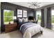 Stylish bedroom with dark accent wall, modern light fixture, and patterned curtains at 4825 Gadwall Way, Cumming, GA 30028