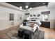 Elegant bedroom with hardwood floors, tray ceiling, and adjacent bathroom at 4825 Gadwall Way, Cumming, GA 30028