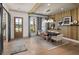 Open dining room with wood accent wall, modern lighting, and a view to the outdoors at 4825 Gadwall Way, Cumming, GA 30028