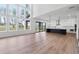 Open floor plan showcases a kitchen with a large center island, hardwood floors, and abundant natural light from large windows at 4825 Gadwall Way, Cumming, GA 30028