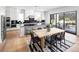 Open concept kitchen includes stainless steel appliances, a large island, and a dining area with hardwood floors at 4825 Gadwall Way, Cumming, GA 30028