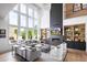 Bright living room features a fireplace, high ceilings, built-in shelving, hardwood floors and natural light from large windows at 4825 Gadwall Way, Cumming, GA 30028