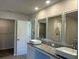 A double sink bathroom vanity boasts elegant vessel sinks, granite countertop, and stylish mirrors at 5381 Tolar Rd, South Fulton, GA 30213