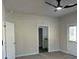The bedroom of the home has grey carpet with white walls and a ceiling fan at 5381 Tolar Rd, South Fulton, GA 30213