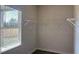 A bright, walk-in closet features a window, shelving, and a hanging rod for optimal storage at 5381 Tolar Rd, South Fulton, GA 30213