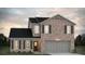 Charming two-story brick home with a dark roof, attached garage, and landscaped front yard at 5381 Tolar Rd, South Fulton, GA 30213