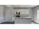 Modern kitchen featuring white cabinets, an island with seating, and stainless steel appliances at 5381 Tolar Rd, South Fulton, GA 30213