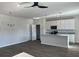 Open concept living room and kitchen with dark floors, modern lighting and a ceiling fan at 5381 Tolar Rd, South Fulton, GA 30213