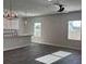 Spacious open living room with a view of the kitchen, stylish light fixture and natural light at 5381 Tolar Rd, South Fulton, GA 30213