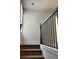 Carpeted stairs with dark wood railing leading to the upper level at 5381 Tolar Rd, South Fulton, GA 30213