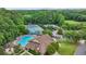 Aerial view of community amenities including the pool, tennis court, clubhouse, and parking area at 10300 Medridge Cir, Johns Creek, GA 30022