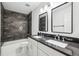 Modern bathroom featuring dual sinks, granite counters, and a shower-tub combination at 10300 Medridge Cir, Johns Creek, GA 30022