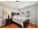Bedroom featuring hardwood floors, large window, and black furniture at 10300 Medridge Cir, Johns Creek, GA 30022
