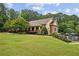 Clubhouse featuring a covered porch, adjacent to lush greenery, a pool and other community amenities at 10300 Medridge Cir, Johns Creek, GA 30022