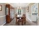 Dining room with hardwood floors, decorative light fixture, and china cabinet at 10300 Medridge Cir, Johns Creek, GA 30022