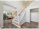 Bright foyer features hardwood floors, staircase and living room view with ample natural light at 10300 Medridge Cir, Johns Creek, GA 30022