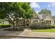 Charming home featuring a stone facade and a well-manicured front yard at 10300 Medridge Cir, Johns Creek, GA 30022