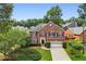 Beautiful brick home with a manicured lawn and a two-car garage in a lovely neighborhood at 10300 Medridge Cir, Johns Creek, GA 30022