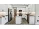 Modern kitchen with white cabinets, stainless steel appliances, and wood-look floors at 10300 Medridge Cir, Johns Creek, GA 30022