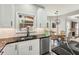 Updated kitchen with dark countertops, stainless steel dishwasher, and a view to the backyard at 10300 Medridge Cir, Johns Creek, GA 30022