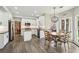 Bright kitchen with white cabinets, stainless steel appliances, and a breakfast nook with a modern chandelier at 10300 Medridge Cir, Johns Creek, GA 30022