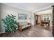 Cozy living room features hardwood flooring, painting and view to dining room at 10300 Medridge Cir, Johns Creek, GA 30022