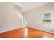 Living room featuring a vaulted ceiling, hardwood floors, and two large windows at 10300 Medridge Cir, Johns Creek, GA 30022