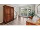 Bright living room with hardwood floors, large windows, and view to entry at 10300 Medridge Cir, Johns Creek, GA 30022
