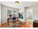 Well-lit office features hardwood floors, a fireplace, and a doorway to the bathroom at 10300 Medridge Cir, Johns Creek, GA 30022