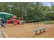 A wide view of the neighborhood playground, showcasing slides, swings, and other play equipment at 10300 Medridge Cir, Johns Creek, GA 30022