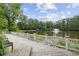 Relaxing pond view from the community boardwalk, showcasing a tranquil setting at 10300 Medridge Cir, Johns Creek, GA 30022