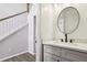 Stylish powder room with sleek vanity, round mirror, and modern fixtures at 10300 Medridge Cir, Johns Creek, GA 30022