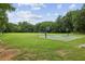 Community recreational field including a soccer goal, and a basketball court surrounded by lush greenery at 10300 Medridge Cir, Johns Creek, GA 30022